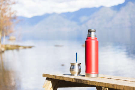 Mate and a thermo full of hot water ready to drink in a natural environment. Latin beverage.の写真素材