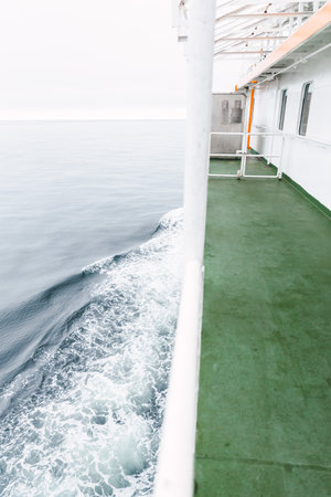 Lateral view of a wake water splash from a ferry boat in the chilean patagonian channels.