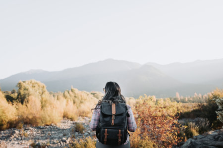Young single traveler woman with a backpack on, looking at the valley, doing trekking to explore nature. Single Hikingの写真素材