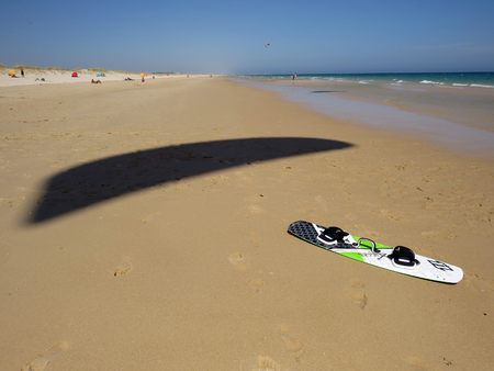 Kitesurf board with wing shadow on the sandのeditorial素材
