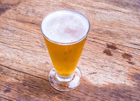 Closeup beer glass on wood background