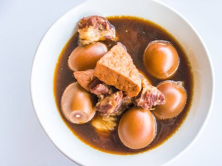 eggs and pork stewed on white bowlの写真素材