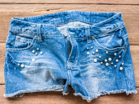 Short jean on wood backgroundの写真素材