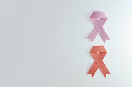 Duo of leukemia and breast strips made of paper with white background.
