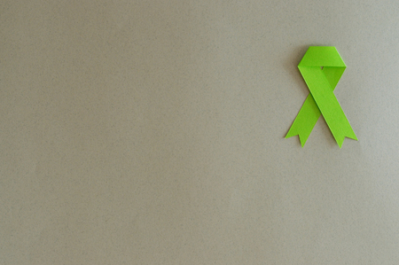 Lymphoma cancer ribbon made with paper on beige background.の写真素材
