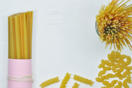 Composition of raw wholegrain pasta on white vintage wooden table.
の写真素材