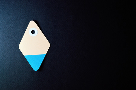 Paper tag on dark background, ideal for your shopping projects or business topics.