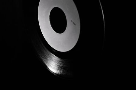 Black and white template of old vinyl disc on dark background.の写真素材