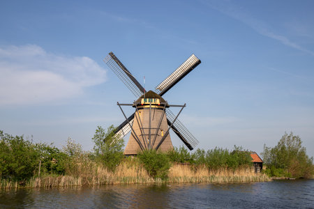 Windmill in Kinderdijk by the riverの写真素材