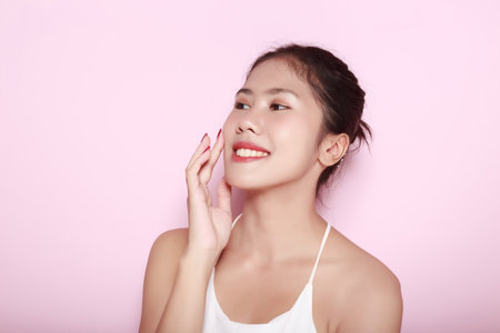 Portrait of beautiful young woman with clean fresh skin on pink background, Face care, Facial treatment. Cosmetology, beauty and spa. Asian women portraitの写真素材