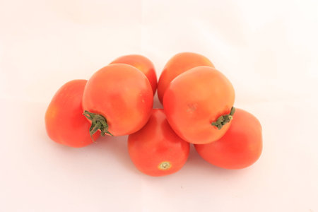 Fresh tomatoes isolated on whiteの写真素材