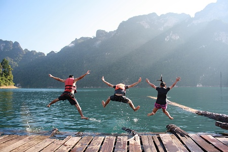 three guy jumping together 