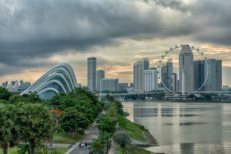 Yellow sky behind Singapore Flyer at sunset from Marina Barrageのeditorial素材