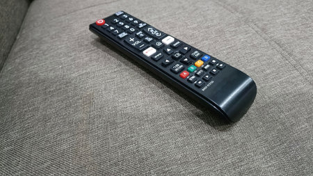 TV remote control on the sofa in the living room of a house