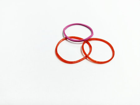 Rubber bands of different colors on a white background close-upの写真素材