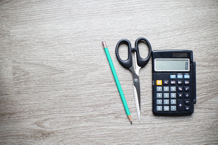 Stationary equipment includes a calculator, scissors and pencils.の写真素材