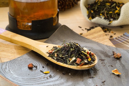 Dry tea with dried fruit on the wooden spoon.の写真素材