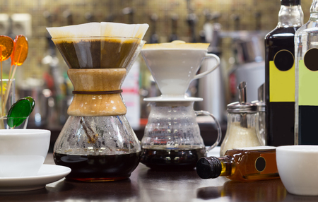 Brew coffee pour-over and chemex on the counter at the coffee shop. The background is blurred.の写真素材