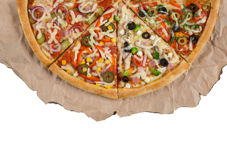 Assorted pizzas on paper on a white background isolated.の写真素材