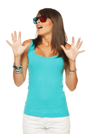 Scared female in three-dimensional eyeglasses with hands raised, against white backgroundの写真素材