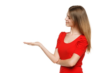 Portrait of young woman holding an empty copy space on the open hand palm, over gray backgroundの写真素材