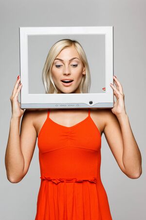 Woman looking throught the screen frameの写真素材