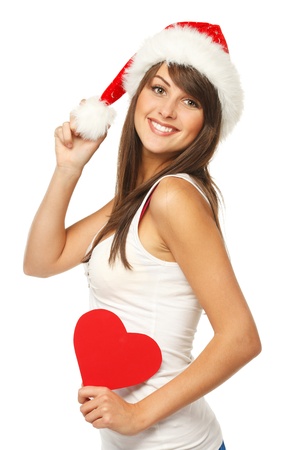 Beautiful girl in Santa hat holding heart shapeの写真素材