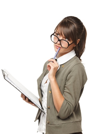 Young pensive woman wearing old fashioned eyeglasses standing with clipboard and a pan looking up, isolated on white background.の写真素材