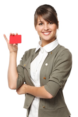 Close-up portrait of young smiling business woman holding credit card isolated on white backgroundの写真素材