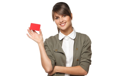 Young smiling business woman holding credit card isolated on white backgroundの写真素材