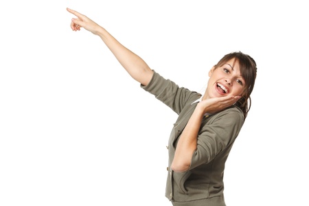 Surprised young female pointing at copy space, over white backgroundの写真素材