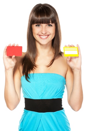 Happy female holding two plastic cards isolated on white backgroundの写真素材