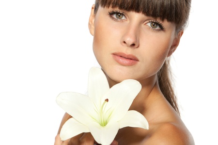 Closeup portrait of beautiful woman face with a flowerの写真素材