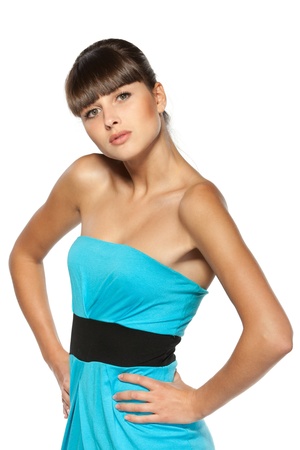 Young female in turquoise coctail dress standing with her hands on the waist isolated on white backgroundの写真素材