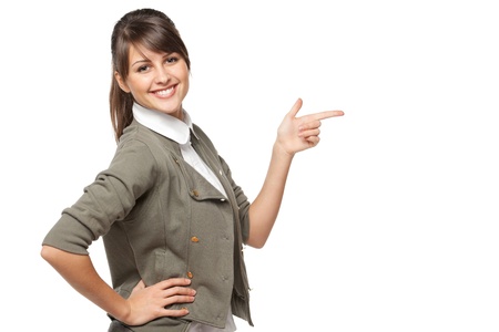 Beautiful brunette business woman pointing at copy space over white backgroundの写真素材