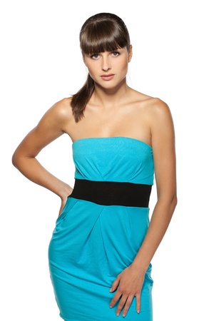 Young female in turquoise cocktail dress posing on white backgroundの写真素材