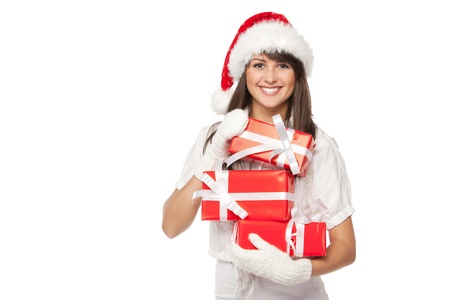 Young smiling girl in Santa hat holding a heap of gift boxes isolated with copy-space over white backgroundの写真素材
