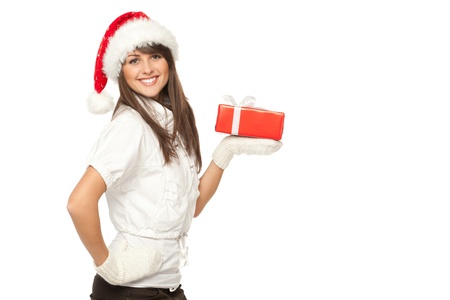Side view of a girl in Santa hat holding a Xmas gift on her palm, isolated on white backgroundの写真素材