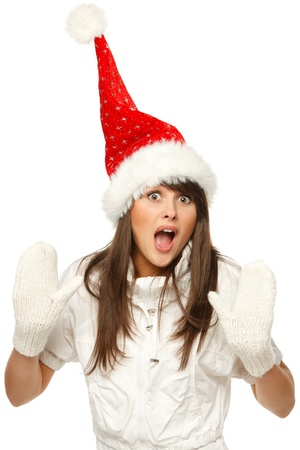 Funny image of a girl in red santa hat shocked and surprised, isolated on white backgroundの写真素材