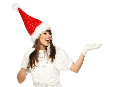 Girl in Santa hat showing a product - empty copy space on the open hand palms, over white backgroundの写真素材