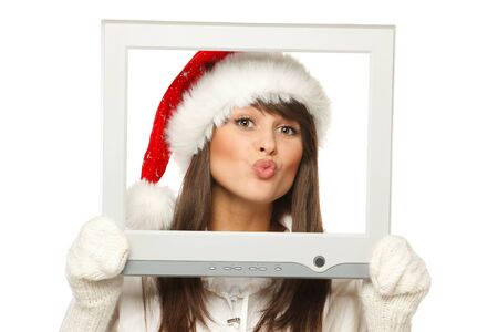 Girl in Santa hat sending you a virtual kiss from TV   computer screen frame, isolated on white background の写真素材
