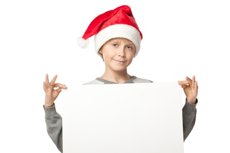 Boy in Santa hat holding a banner, isolated on white backgroundの写真素材