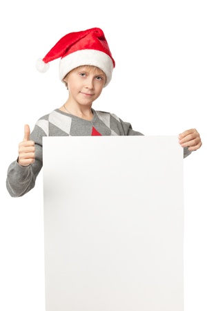 Boy in Santa hat holdingblank banner showing thumb up sign, isolated on white backgroundの写真素材
