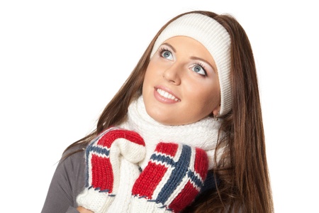 Closeup of a girl in warm clothing looking upwards, over white background Closeup of a girl in warm clothing looking upwards, over white background