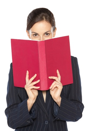 Female in business suit peeking overthe book, isolated on white backgroundの写真素材