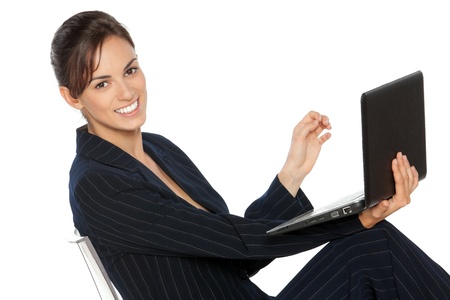 Young business woman working on laptop, isolated on white backgroundの写真素材