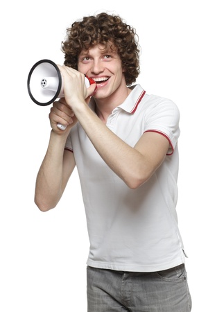 Happy man making announcement over a megaphone, looking upwards against white backgroundの写真素材