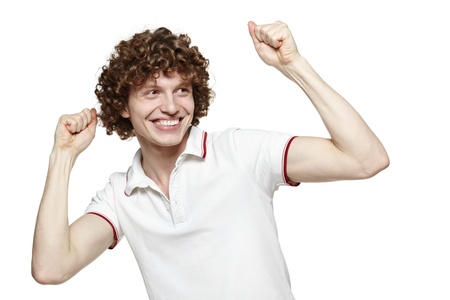 Portrait of a very happy young man with his arms raised, over white backgroundの写真素材
