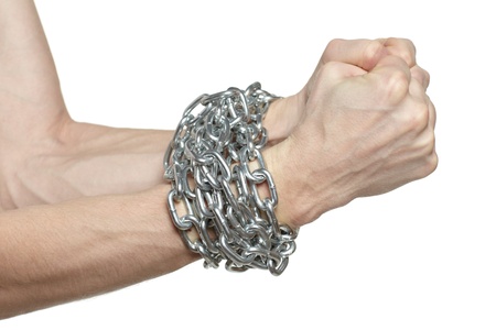 Man hands fettered with chain, job slave symbol, isolated on white backgroundの写真素材