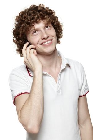 Happy man answering the phone against a white backgroundの写真素材